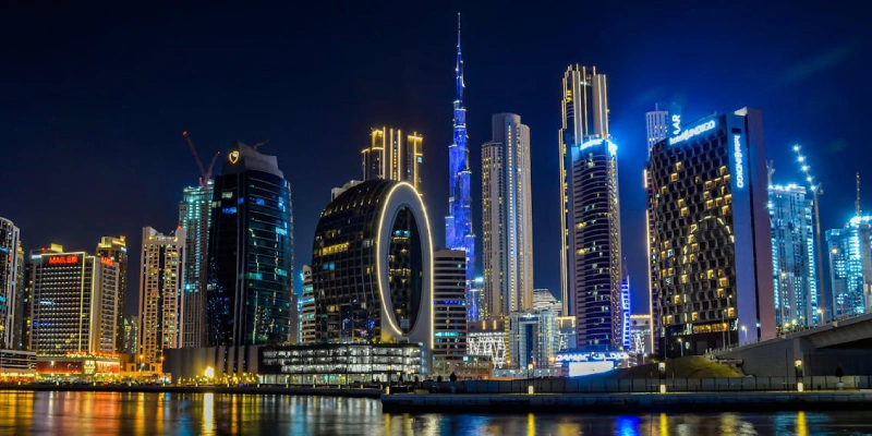 Night view of Burj Khalifa lit up with dazzling lights and reflections
