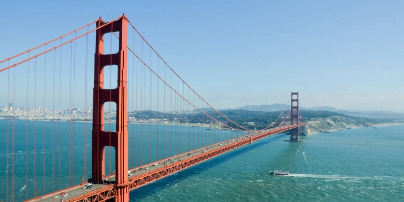 Tourists walking across the Golden Gate Bridge on a clear day in California