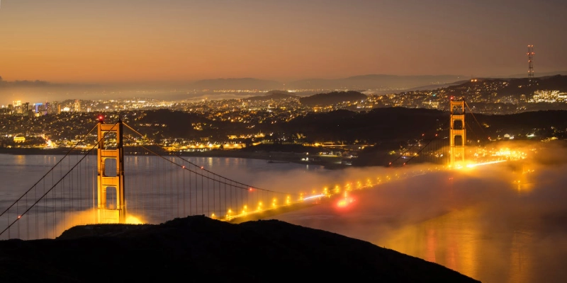 Iconic red towers of the Golden Gate Bridge with vehicles crossing the span