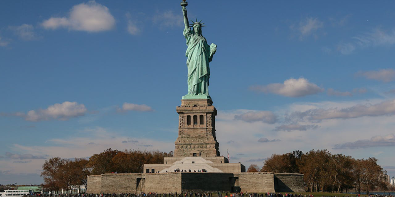 Panoramic view of the Statue of Liberty with Manhattan skyline in the background