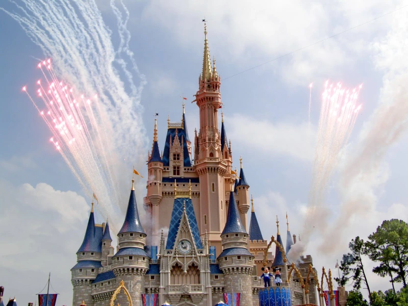 Walt Disney World theme park entrance with Cinderella Castle in the background during sunset